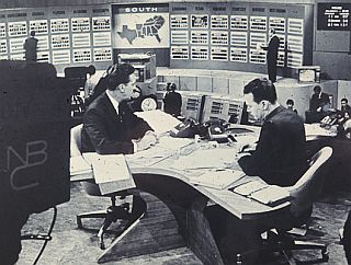 Nov 8, 1960: Election-night coverage by NBC-TV team of Chet Huntley & David Brinkley at desk, with posted election returns.