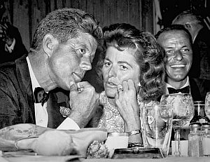 July 10th: JFK chats with sister Pat during fundraising dinner at the Beverly Hilton Hotel, with VIP guests such as Frank Sinatra (rt). Photo, L.A. Mirror-News.