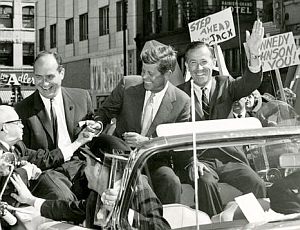 Sept 6, 1960: JFK’s car in Spokane, WA is surrounded by crowds in downtown area as he campaigns with Gov. Albert D. Rosellini (L) and Sen. Henry “Scoop” Jackson (waving), then DNC chairman. 