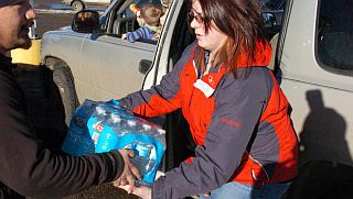 Jan 20, 2015: Whitney Schipman of Glendive, MT receives a case of bottled drinking water. AP Photo/Matthew Brown