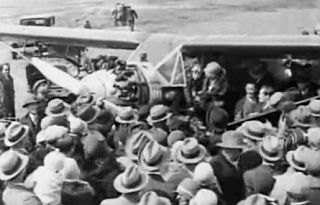 Crowd of admirers gathering around Elinor Smith's plane on arrival at airfield after one of her record-setting flights.