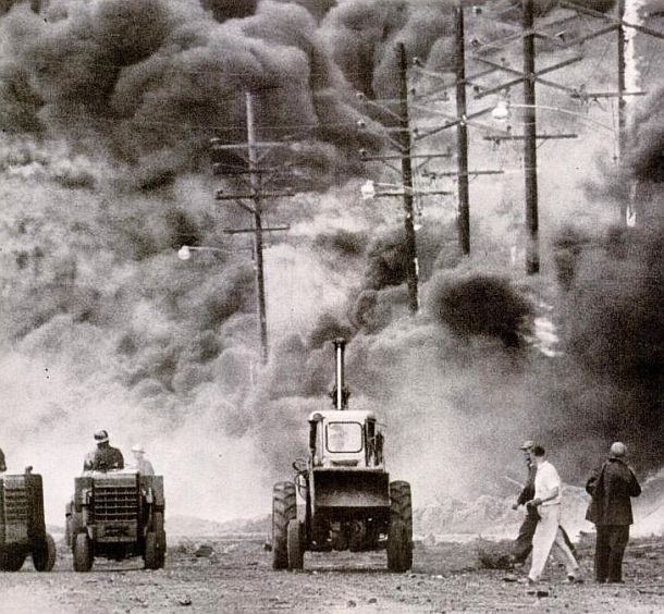 Aug 1955: Life magazine photo of Standard Oil workers at Whiting trying to contain burning oil and sequential tank explosions by building sand barricades to keep the oil & fire from spreading to other parts of the 1,660-acre refinery.