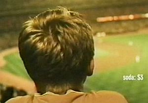 Frame from MasterCard TV ad, "Family of Four - Summer Wind," depicting a family at an L.A. Dodgers baseball game away from modern distractions. Click to view ad.