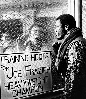 January 28, 1971: Muhammad Ali, with a small crowd behind him, appears outside Joe Frazier’s gym in Philadelphia, PA to taunt him. Photo, Associated Press.