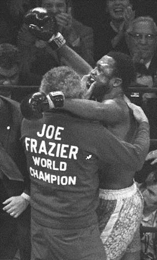 March 1971. Joe Frazier, celebrating his victory over Muhammad Ali with his corner crew. AP photo.