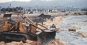 1969: Bulldozers formed piles of oil-soaked sand and cleanup wastes on the beaches in Santa Barbara that were hauled away to landfills by large trucks.