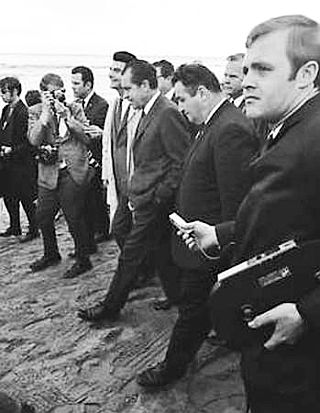 March 21, 1969: President Richard Nixon (hands in pocket, center) walks on Santa Barbara beach with reporters.