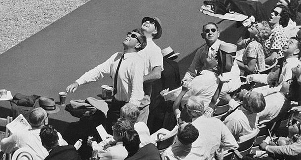 July 1962: After the president’s party shed their jackets and settled in for the All-Star game seated behind a dugout, JFK and his aide, Dave Powers, rise from their seats tracking a foul ball hit in their direction.