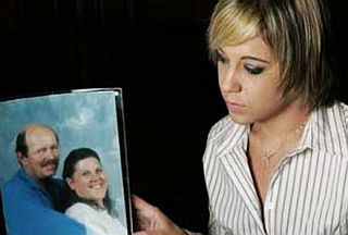 Eva Rowe, holding a portrait photograph of her parents, James (44) and Linda (43) Rowe, killed in the BP explosion.