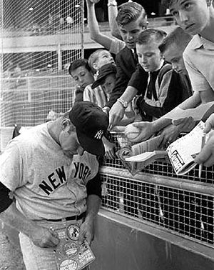 1965: Mickey Mantle of the New York Yankees signing autographs for young fans in Houston, Texas.
