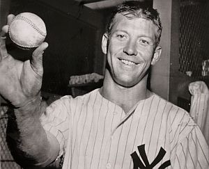 Mickey Mantle holding a home run ball he hit some years earlier at Yankee Stadium in a July 1957 game that traveled an estimated 465 feet.