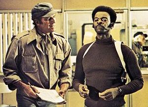 At police headquarters, Thorn visits with chief detective Hatcher (Brock Peters) to go over the Simonson case.