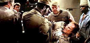 Thorn on stretcher after gun battle, pleads with Hatcher to spread the truth about Soylent Green .