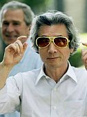 Geo. Bush smiles as Junichiro Koizumi tries on a pair of Elvis shades.