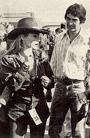 1973 Newsweek photo of John DeLorean shown with actress Ursula Andress at an outdoor event.