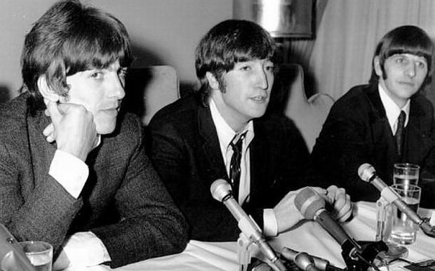 August 11, 1966: John Lennon of the Beatles, center, is flanked by George Harrison, left, and Ringo Starr as he apologizes for his remark that "the Beatles are more popular than Jesus," at a Chicago news conference.