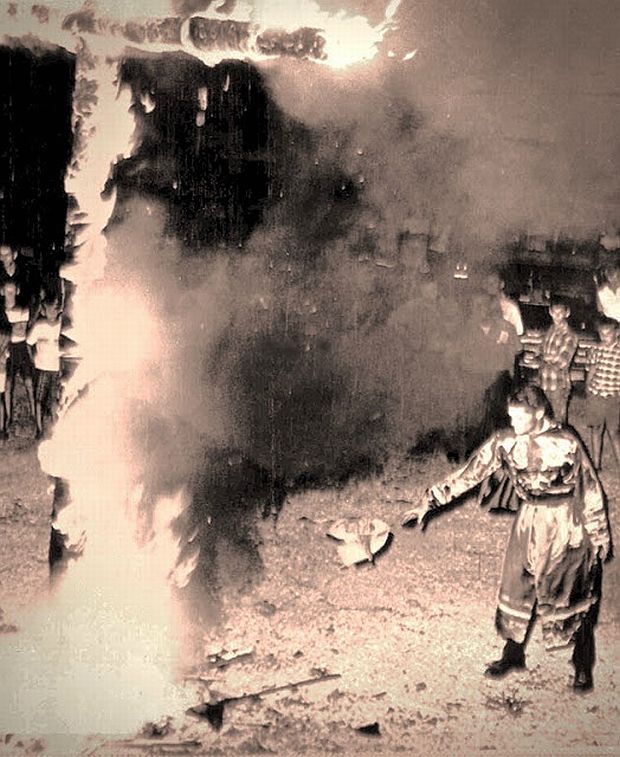 August 11, 1966: South Carolina KKK Grand Dragon, Bob Scoggin, tossing Beatle records into the fire of a burning cross at Chester, South Carolina. Photo, Associated Press.