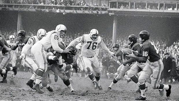 December 28, 1958 NFL championship game at Yankee Stadium, as New York Giant’s halfback, Frank Gifford, No. 16, looks for running room as Baltimore Colt defenders – including “Big Daddy” Lipscomb No 76 -- close in.