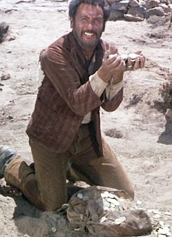 Tuco is overjoyed at finding the gold.