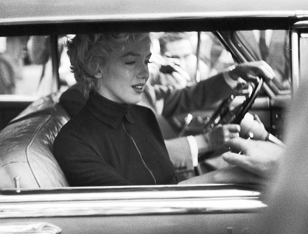 October 1954. A tearful Marilyn Monroe in car with her attorney after announcing to the Hollywood press her intention of seeking a divorce from Joe DiMaggio.