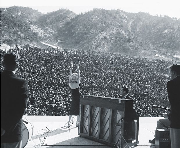 February 1954.  Marilyn Monroe, center stage, entertaining U.S. troops in Korea, at one of the ten USO shows she did there during a four-day tour of U.S. troop bases.