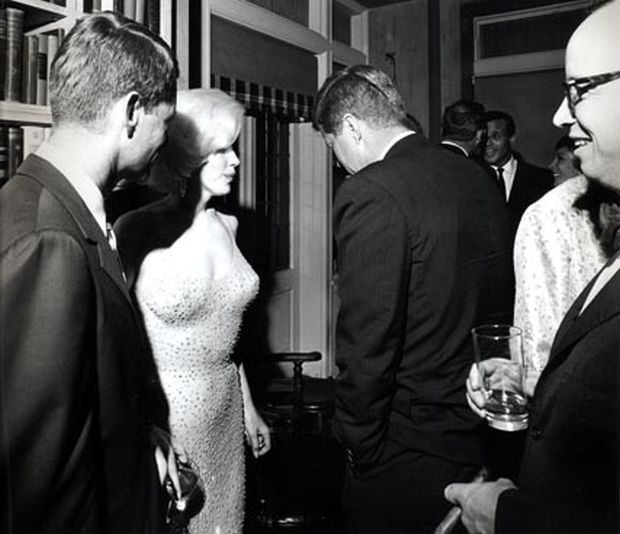 May 19, 1962.  Robert F. Kennedy, Marilyn Monroe, and John F. Kennedy in rare photo taken at private “after party.” Advisor and historian Arthur Schlesinger, with glasses, is shown at far right holding drink.  Photo, Cecil Stoughton.
