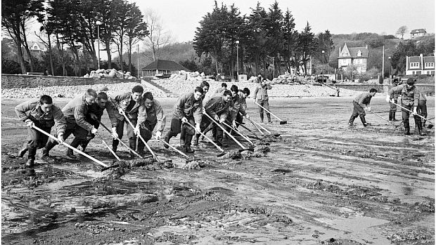 French soldiers were brought in to clean up the oil on the beach at Perros-Guirec, France.